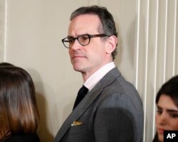 FILE - Michael Anton waits in the East Room of the White House in Washington of the start of President Donald Trump's news conference, Feb. 16, 2017.