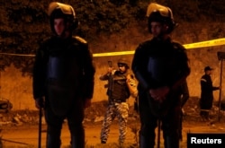 Police secure the area around a bus hit by a bomb in Giza, Egypt, Dec. 28, 2018.