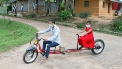 An engineer rides his specially-designed bicycle near Agartala, India with his daughter.