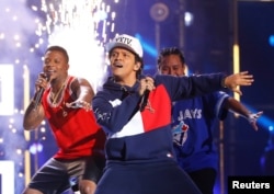 FILE - Bruno Mars performs on stage at the 2016 MTV Europe Music Awards at the Ahoy Arena in Rotterdam, Netherlands, Nov. 6, 2016.
