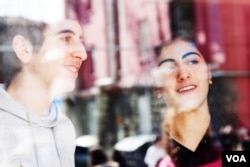 FILE - Aren Kurumlian chats with his classmate Hagop Pontigian, also from Aleppo. They study in a Yerevan high school, with a large percentage of students from Syria, February 20, 2013. (V. Undritz/VOA)