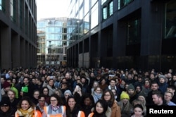 Workers stand outside the Google offices after walking out as part of a global protest over workplace issues in Dublin, Ireland, Nov. 1, 2018.