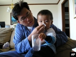 This lad’s OK. He’s blowing his nose out of public view.