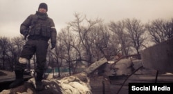 Ukraine -- Bato Dambayev near a checkpoint in the eastern city limits of Vuhlehirsk, Ukraine, a city near Debaltseve where Bato and other Russian soldiers fought in mid-February