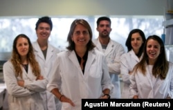 Marina Simian, a medical researcher, poses for a picture with members of her team May 9, 2019. (REUTERS/Agustin Marcarian)