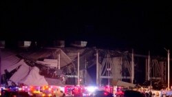 Emergency vehicles are outside an Amazon fulfillment center after it was heavily damaged when a strong thunderstorm moved through the area Dec. 10, 2021, in Edwardsville, Ill.