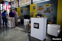 FILE - A view of the booth of Rimco, Caterpillar Inc's dealer for Cuba, at the 35th Havana International Fair in Havana, Cuba, Nov. 1, 2017.