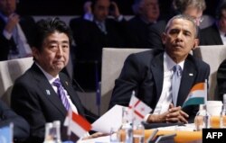 FILE - Japanese Prime Minister Shinzo Abe and President Barack Obama attend the opening session of the Nuclear Security Summit in The Hague, March 24, 2014.