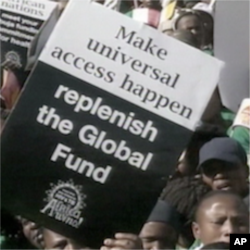 Des manifestants plaident pour un acces universel aux traitements anti-sida et un financement accru.