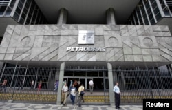 FILE - People enter the headquarters building of Brazilian state oil company Petrobras in Rio de Janeiro.