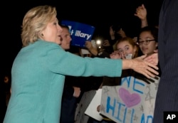 Democratic presidential nominee Hillary Clinton greets people outside on the street as she leaves a fundraiser in Piedmont, Calif., Tuesday, Aug. 23, 2016.