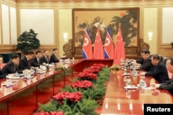 North Korean leader Kim Jong Un attends a meeting with Chinese President Xi Jinping in Beijing, as he paid an unofficial visit to China, in this undated photo released by North Korea's Korean Central News Agency (KCNA), March 28, 2018.