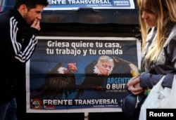 FILE - A poster depicts U.S. District Court Judge Thomas Griesa, overseeing a case in which U.S. hedge funds are suing Argentina, as a vulture in Buenos Aires, Aug. 12, 2014.