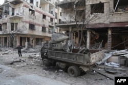 A Syrian man pauses near destruction following a reported regime air strike in the rebel-held town of Hamouria, in the besieged Eastern Ghouta region on the outskirts of the capital Damascus, Feb. 21, 2018.