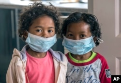 Children wear face masks at a school in Antananarivo, Madagascar, Oct. 3, 2017.