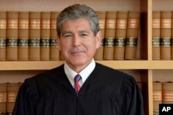 FILE - U.S. District Court in the Southern District of California shows Judge Dana Sabraw in San Diego, July 17, 2018.