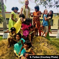 Mother and daughter Sasha and Maya Forbes teach English while playing with Bangladeshi girls in Khulna, Bangladesh, April 2018. The girls are part of the Alingon Home, a safe place for more than 20 girls who have been removed from brothels.