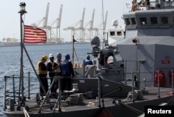 FILE - US troops stand on a military ship during a joint naval exercise with Qatari troops in the Arabian Gulf, Qatar, June 16, 2017.