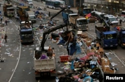 An area previously blocked by pro-democracy supporters is cleared outside the government headquarters in Hong Kong, Dec. 11, 2014.