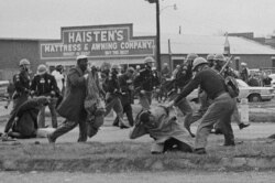 State troopers swing billy clubs to break up a civil rights voting march in Selma, Ala., March 7, 1965. John Lewis, chairman of the Student Nonviolent Coordinating Committee (in the foreground) is being beaten by a state trooper.