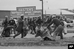 FILE - State troopers swing billy clubs to break up a civil rights voting march in Selma, Ala., March 7, 1965. John Lewis, chairman of the Student Nonviolent Coordinating Committee (in the foreground) is being beaten by a state trooper. (AP Photo)
