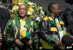 In this file photo taken on July 31, 2016 South African ruling party African National Congress (ANC) president Jacob Zuma (L) and deputy Cyril Ramaphosa arriving for an ANC rally