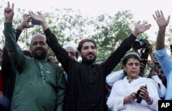 Manzoor Pashteen, center, a leader of the Pashtun Protection Movement waves to his supporters during a rally in Lahore, Pakistan, April 22, 2018.