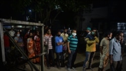 People queue up and camp overnight to get their jab of the COVID-19 vaccine on the following day at the government-run district hospital in Siliguri on September 20, 2021.
