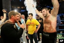 Chechen leader Ramzan Kadyrov, left, congratulates Uzbekistan's "White Tyson" Ruslan Chagaev, right, while celebrating his victory over American Fres Oquendo after their WBA heavyweight boxing championship fight at Ahmat Arena, in Grozny, Russia.