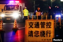Policemen take position along Beijing's main east-west thoroughfare, Changan Avenue, near the Great Hall of the People in Beijing, China, March 26, 2018.