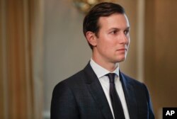 FILE - White House senior adviser Jared Kushner listens to a presidential exchange with reporters at Trump National Golf Club in Bedminster, N.J., Aug. 11, 2017.