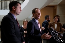 House Intelligence Committee Chairman Rep. Devin Nunes, listens at left, as the committee's ranking member Rep. Adam Schiff, D-Calif., talk to reporters on Capitol Hill, March 2, 2017.