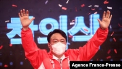 FILE - Former prosecutor general Yoon Seok-youl from South Korea's main opposition People Power Party waves after being chosen as the party's candidate in next year's presidential election in Seoul on Nove. 5, 2021.
