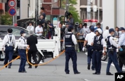 Police officers work at the scene where a man wielding a knife attacked a group of schoolchildren in Kawasaki, near TokyoMay 28, 2019.