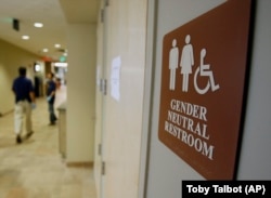 In this August 23, 2007, file photo, a sign marks the entrance to a gender-neutral restroom at the University of Vermont in Burlington, Vermont.