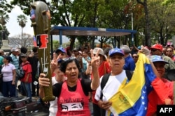 Supporters of Venezuelan President Nicolas Maduro take part in a pro-government "anti-imperialist rally" in Caracas, March 30, 2019.