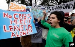 Groups opposed to border walls being built along the Texas-Mexico border gather outside the McAllen International Airport as they wait for the arrival of President Donald Trump, Jan. 10, 2019, in McAllen, Texas.