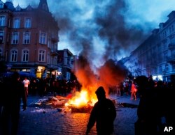 Protesters gather between fires on a street during a protest against the G-20 summit in Hamburg, Germany, July 7, 2017.