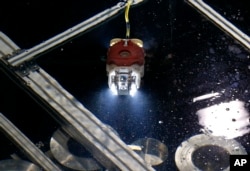 A newly developed robot for underwater investigation of a Fukushima damaged reactor moves through the water at a test facility in Yokosuka near Tokyo, June 15, 2017.