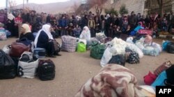 Syrians wait for the arrival of an aid convoy on Jan. 11, 2016 in the besieged town of Madaya as part of a landmark six-month deal reached in September for an end to hostilities in those areas in exchange for humanitarian assistance.