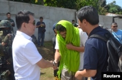 Park Chul-hong, skipper of the South Korea-registered carrier DongBang Giant 2, is greeted by former Sulu Gov. Abdusakur Tan after he was freed by militants of the Abu Sayyaf group, at Jolo airport in Sulu, southern Philippines, Jan. 14, 2017.