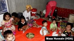 FILE - Some Rohingya women and children in an unidentified refugee colony in West Bengal, eastern India, April 2018.