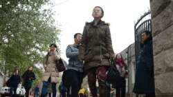 FILE - Chinese middle school students take a break in Beijing.