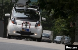 FILE - An autonomous self-driving vehicle goes onto the road during a demonstration in October 2015 in Singapore.