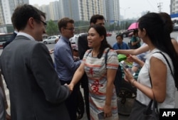 Fan Lili (C), the wife of detained activist Gou Hongguo, and other wives of detained layers meets with foreign diplomats near an office of the Supreme People’s Procuratorate after attempting to hand in a formal complaint about being denied access to their husbands, in Beijing on July 4, 2016.