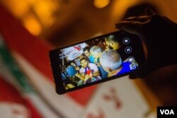 The "You Stink" movement and activists used mobile phones to document the protests against the country's rubbish crisis and subsequent police brutality, with footage often picked up by mainstream media. (John Owens for VOA)