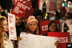 FILE - Lesbian and Gay Rights activists take part in a demonstration aimed to coincide with the upcoming Winter Olympics in Sochi, against laws aimed at stifling Gay Rights in Russia, opposite Downing Street in London, Feb. 5, 2014.