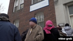 People wait in line for food assistance at the Catholic Charities center in Washington, D.C.’s Columbia Heights neighborhood. Many spoke openly of their fears of being deported.