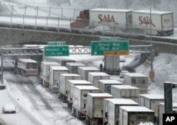 Early morning traffic is at a standstill on Interstate 5 headed into town as a semi truck and cars block the off ramp to Highway 217 above in Portland, Oregon, Jan. 11, 2017.