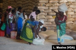 Displaced flood victims share relief items, in Nsanje, Malawi.